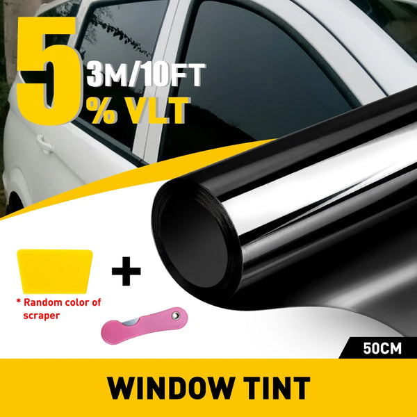 Close-up of a window tint film roll and a pink scraper for automotive window tinting.