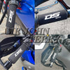 Close-up view of a black DS 900 handlebar grip cover installed on a blue motorcycle.