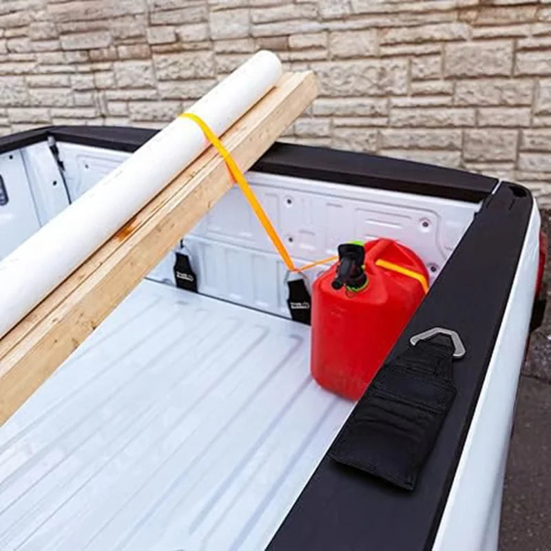 A heavy-duty bed anchor is shown with a white rope and wooden plank inside a truck tailgate.