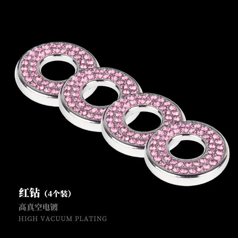 A set of four pink rhinestone car door lock decorations with silver metal rings.