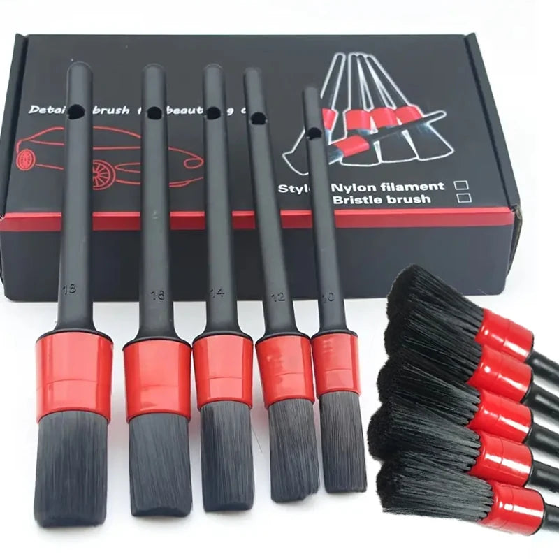 A set of professional car detailing nylon bristles and bristle brushes in black and red on a dark box.