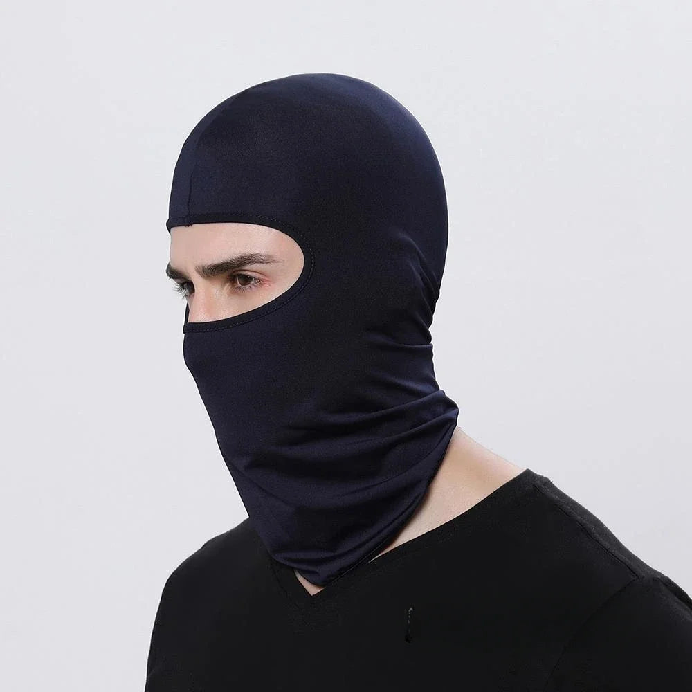 A person wearing a dark blue balaclava face mask for motorcycling.