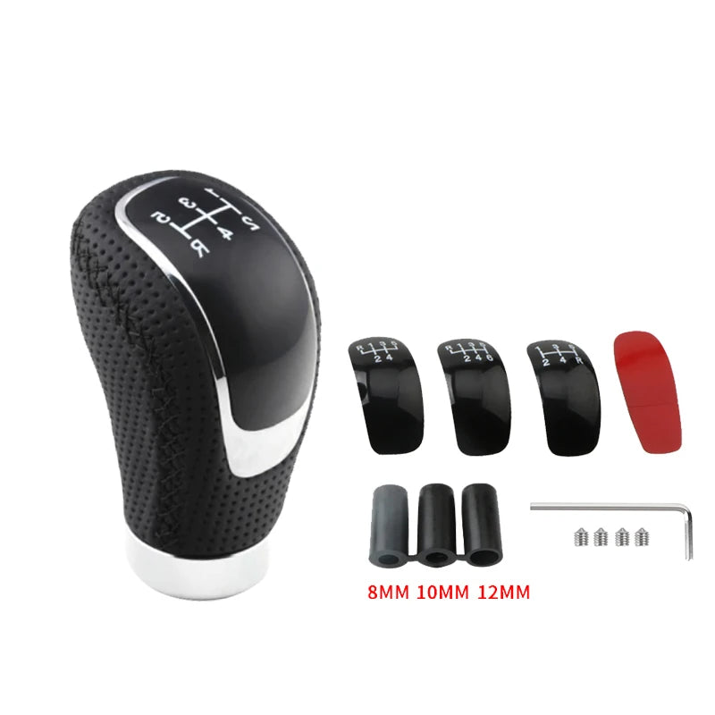 Black manual gear shift knob with interchangeable speed covers and various sized metal pins