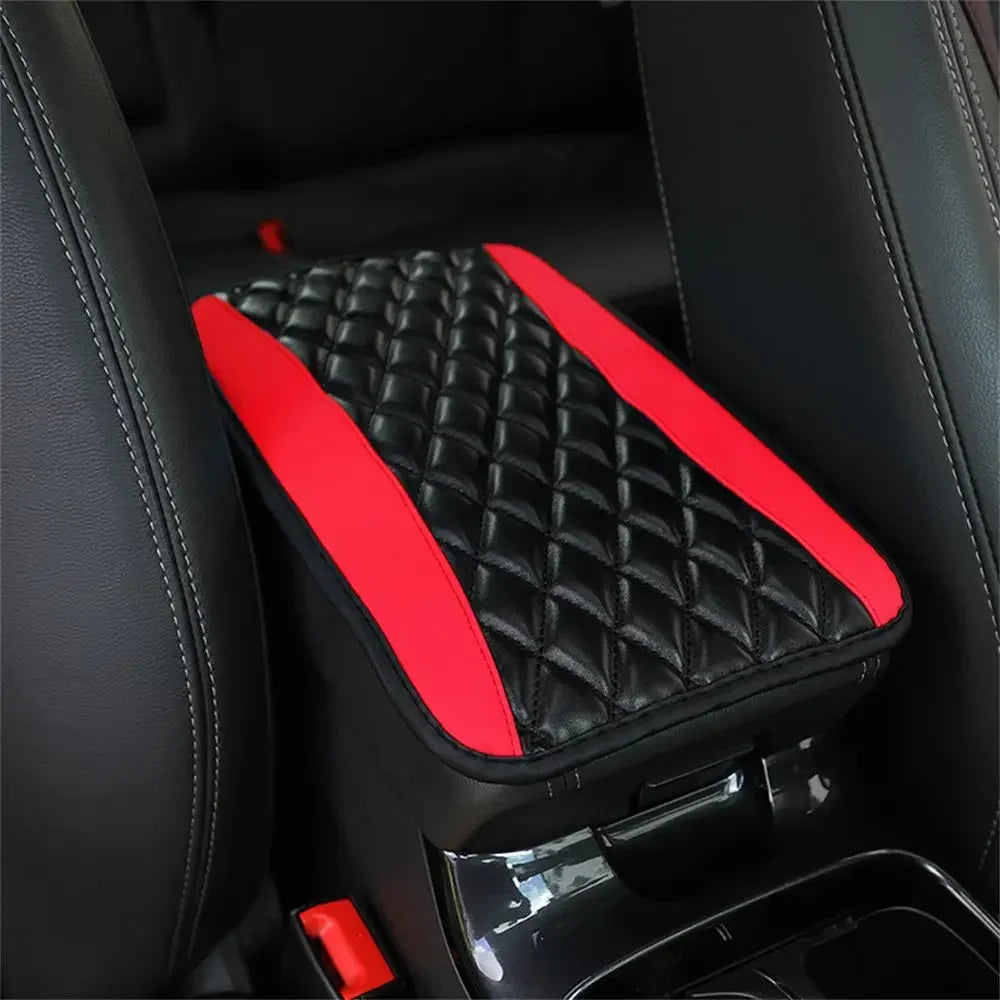 A black quilted armrest protector pad with a red accent is shown inside a car interior.