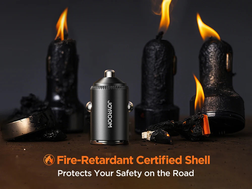 A black fire-retardant certified shell car charger with dual ports is shown next to burning candles.