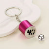 A shiny magenta and silver keychain with a textured design is shown against a white background.