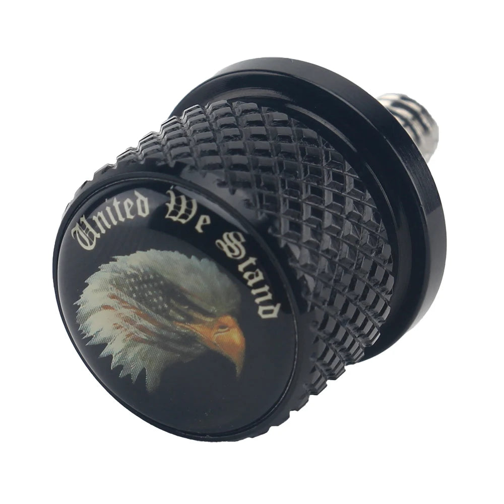 Black aftermarket motorcycle seat and fender bolts with a textured surface and an engraved eagle design.