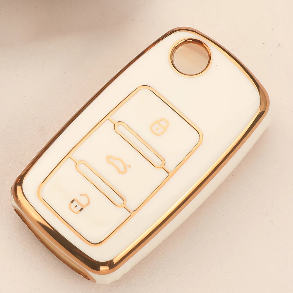 A white silicone TPU car key cover protector with gold accents and a circular opening.