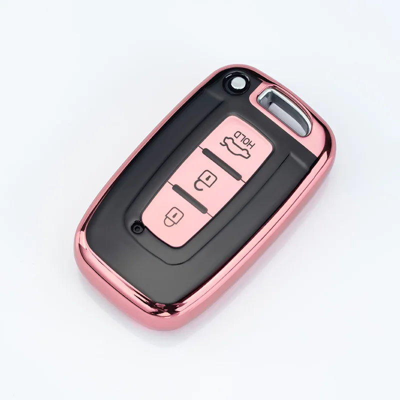 A pink metallic car key case cover with multiple slots for different models.