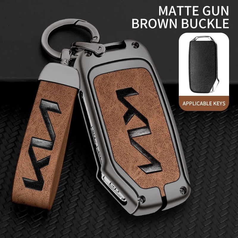 A matte gun brown buckle key case with a silver metal loop and leather strap shown on a black background.