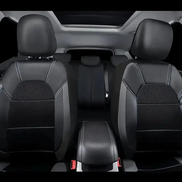 Interior view of a car with black PU leather seat covers installed on the front seats.