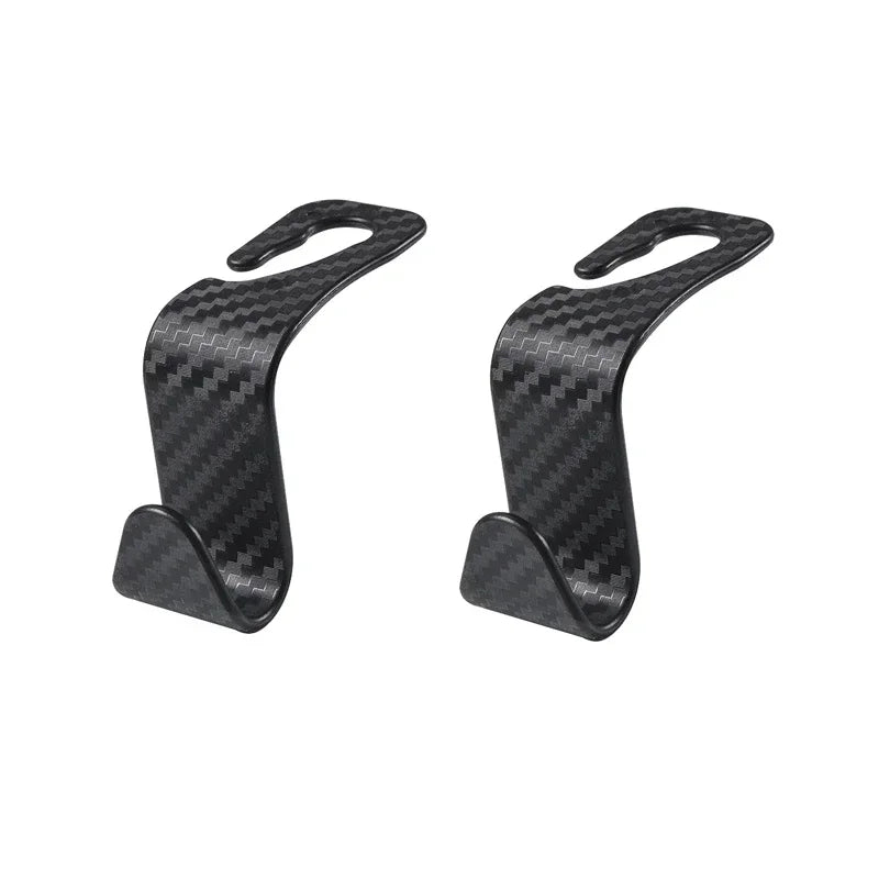 A pair of black carbon fiber storage hooks designed for car seat back headrests.