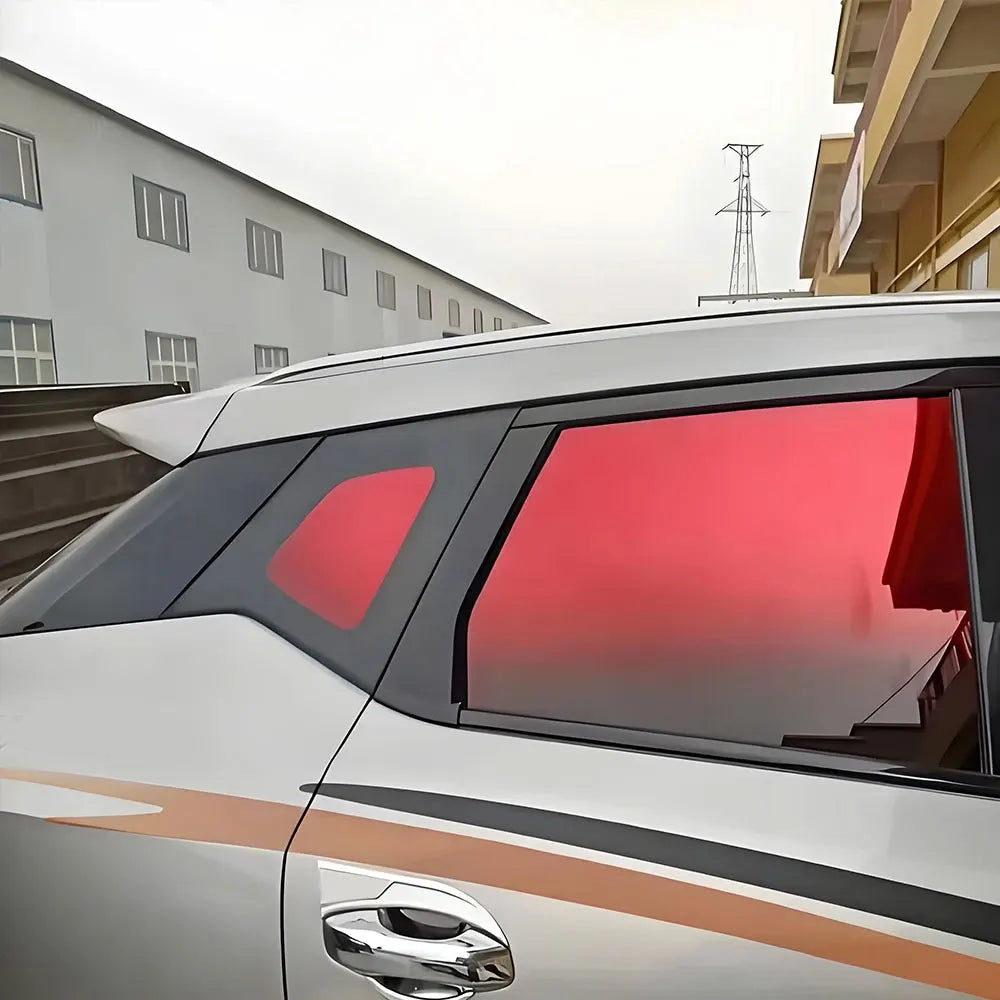 Side profile of a silver car showing a red gradient tint film on the rear passenger window.