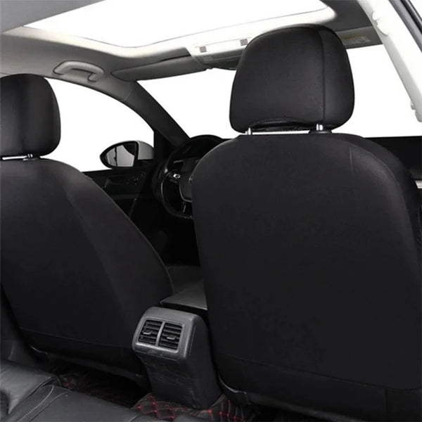 Black universal PU leather car seat covers installed in a vehicle interior.
