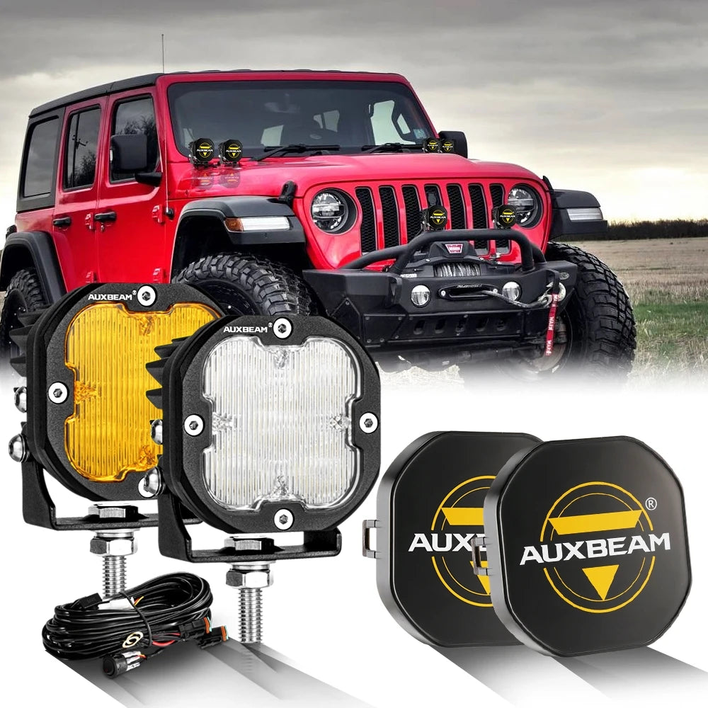 A red Jeep Wrangler equipped with AUXBEAM LED off-road driving lights and separate auxiliary light pods.