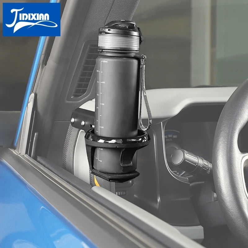 A black cup holder attachment is installed on a vehicle's interior, visible through the door frame.