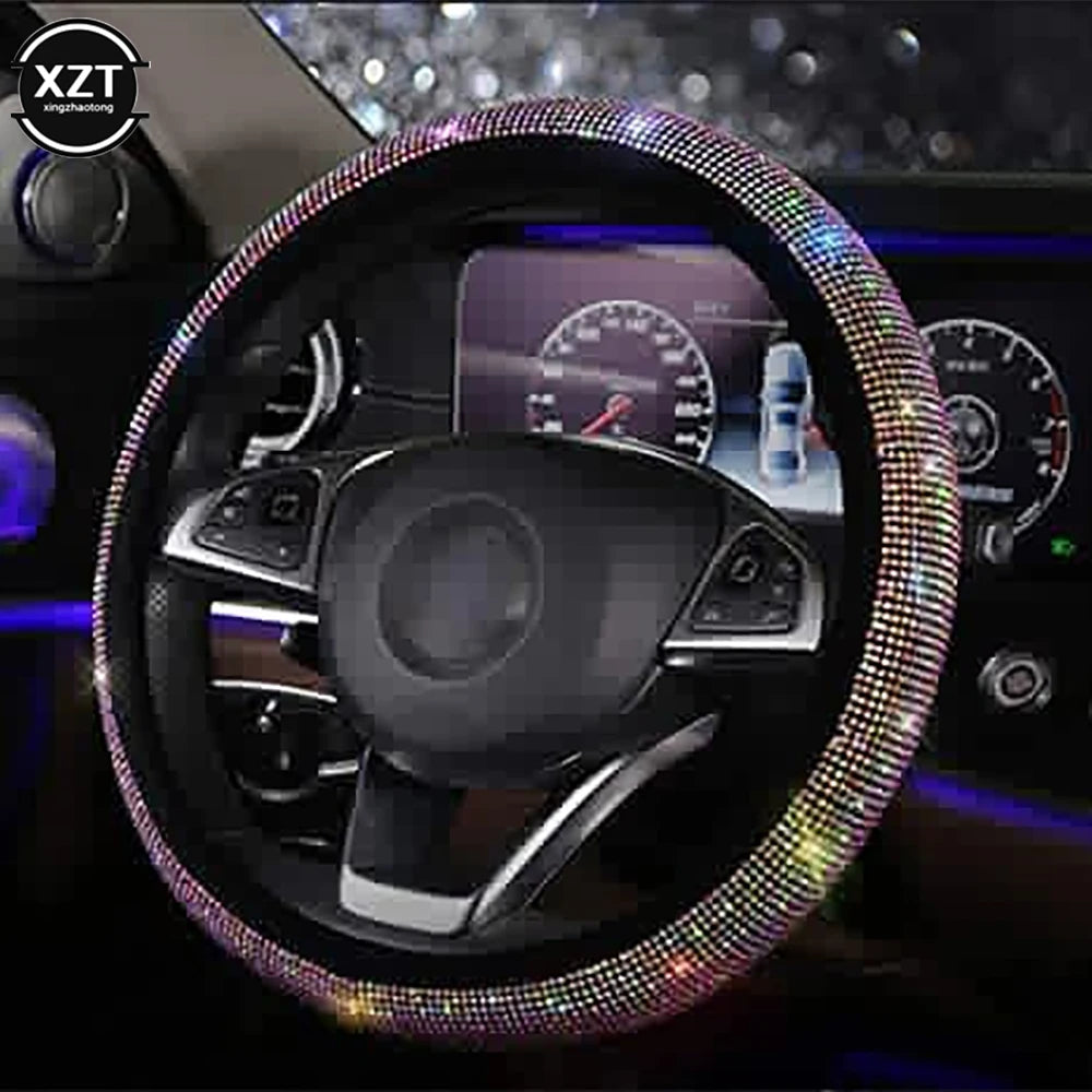 A close-up view of a black steering wheel covered in sparkling crystal rhinestones.