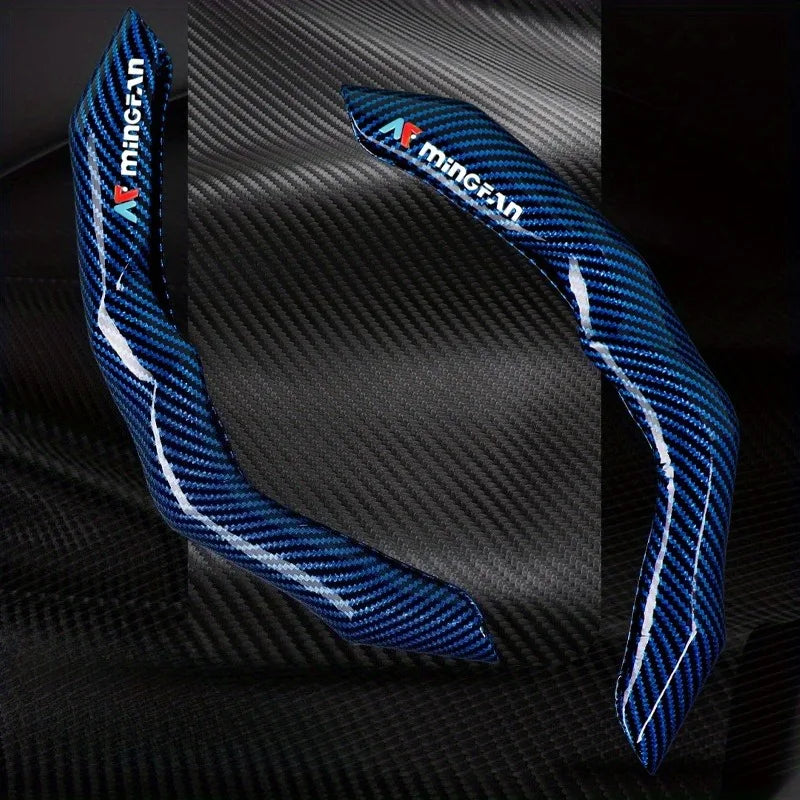 Blue and white Minigran carbon fiber steering wheel cover displayed against a dark background.
