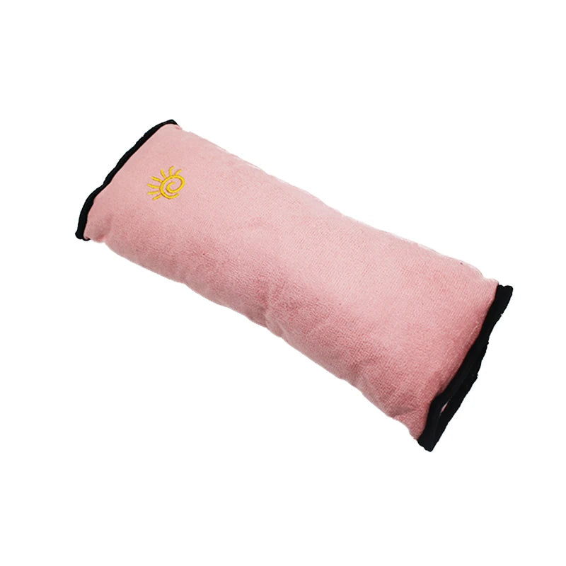 Pink shoulder cushion for a car seat belt featuring a gold sun design.