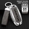 A bright silver grey buckle key cover with a leather strap and multiple applicable keys displayed on a black background.