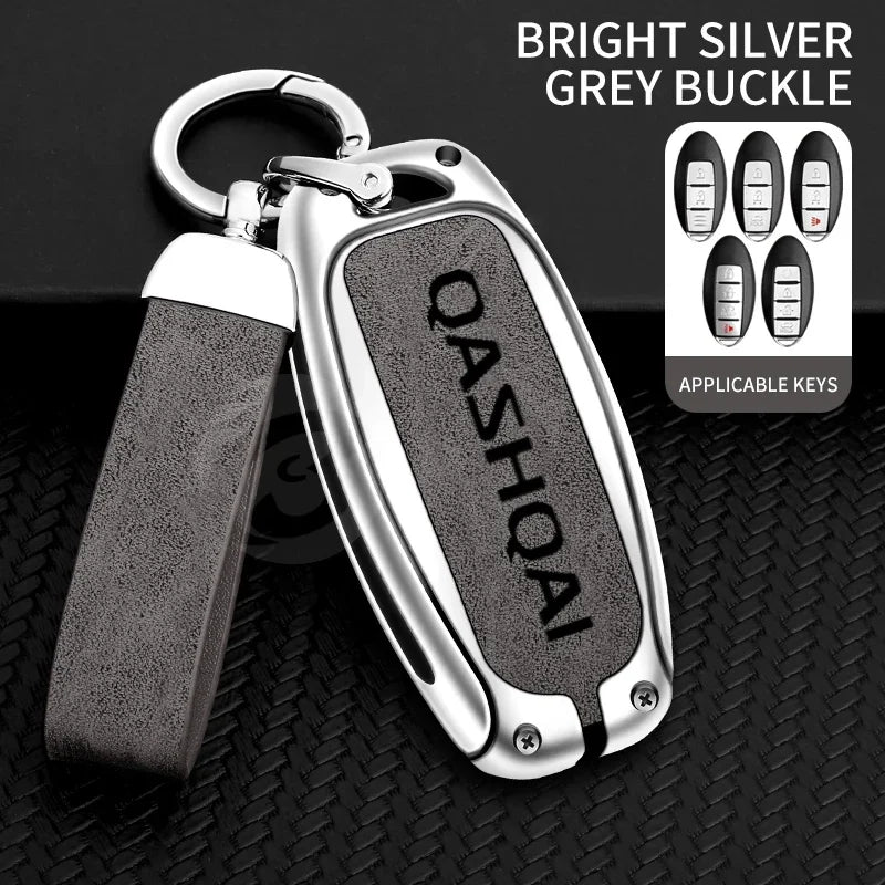 A bright silver grey buckle key cover with a leather strap and multiple applicable keys displayed on a black background.