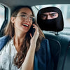 A woman wearing glasses and a white shirt is looking at a black eye print car seat headrest cover.
