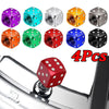 Four colored aluminum dice valve caps displayed above a chrome tire valve stem.
