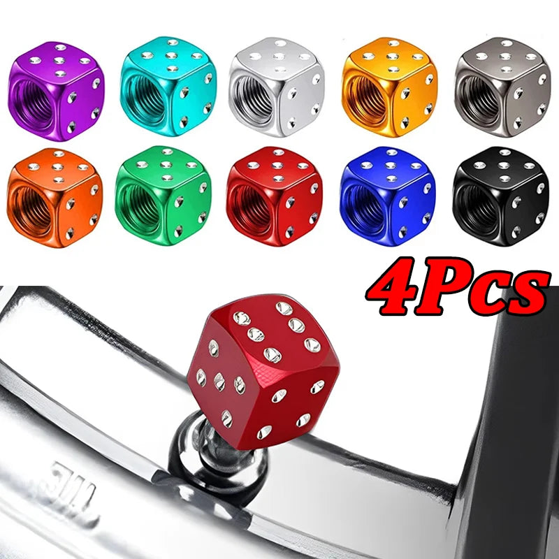 Four colored aluminum dice valve caps displayed above a chrome tire valve stem.