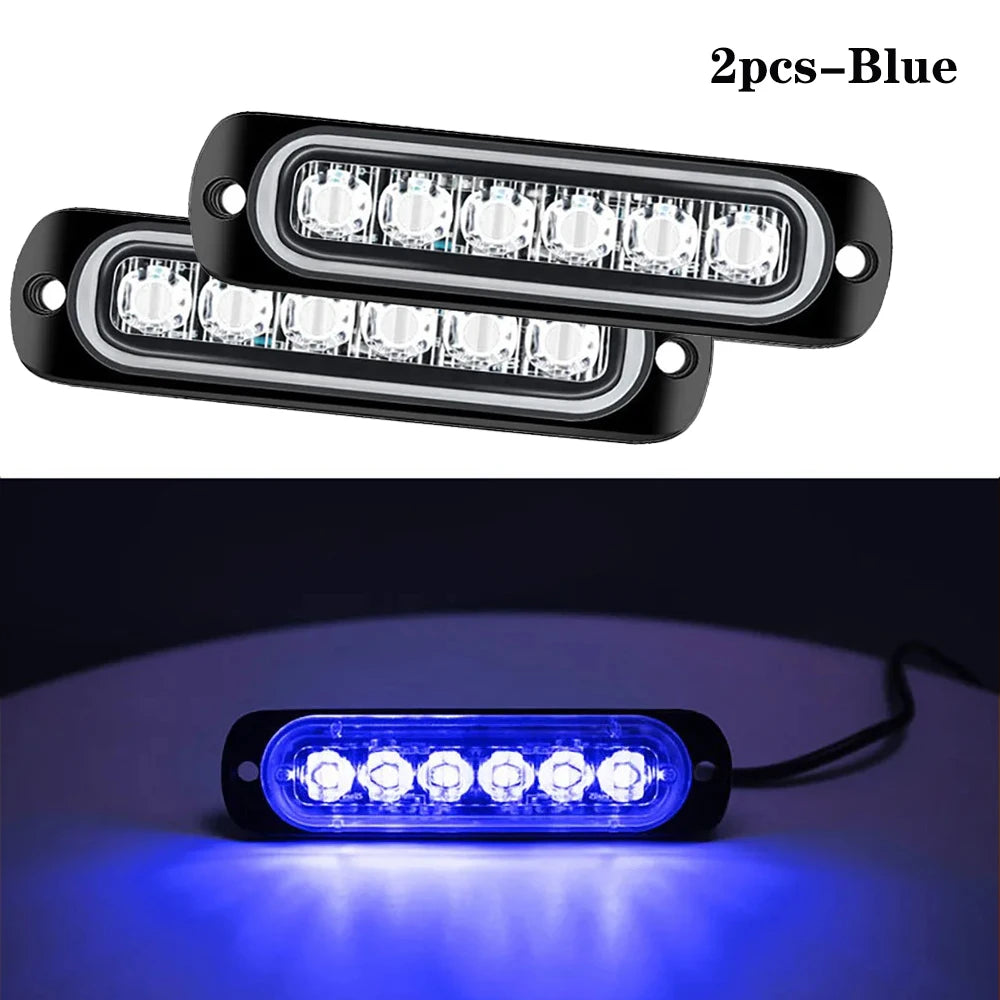 Deux feux stroboscopiques LED bleus montés sur un boîtier noir, illuminant la surface en dessous.