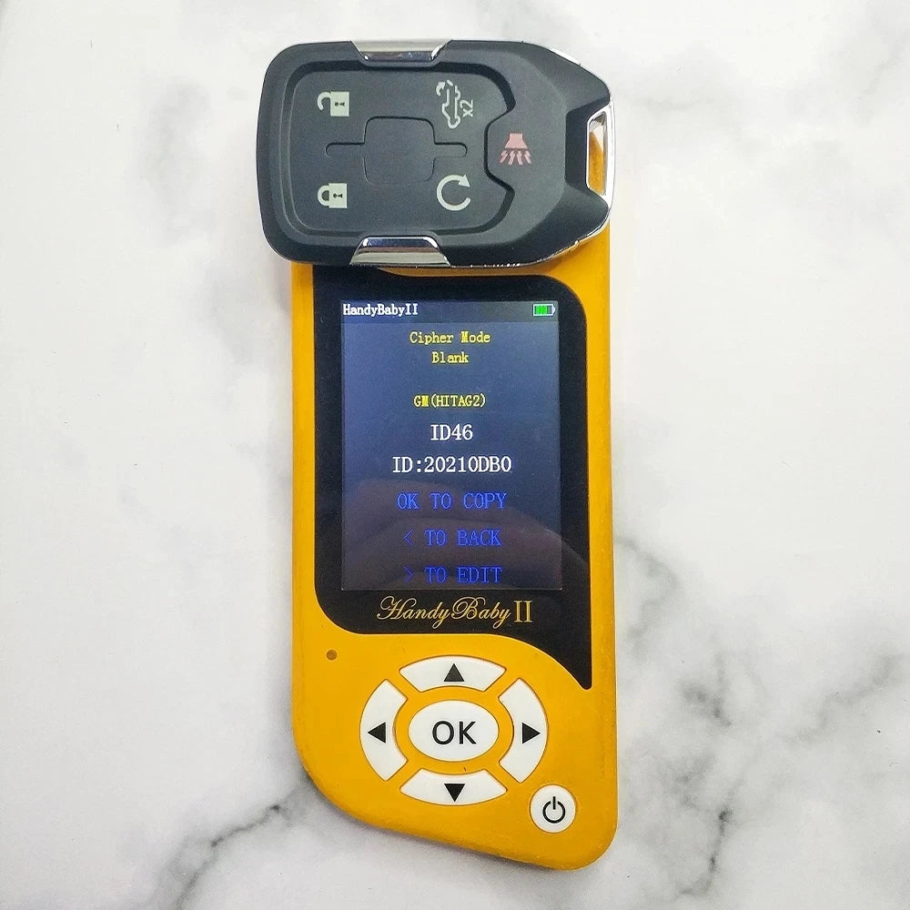 A yellow electronic device labeled HandyBaby II with a black case, resting on a white marble surface.