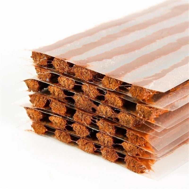 A stack of natural rubber tire repair strips with alternating light and dark brown stripes.