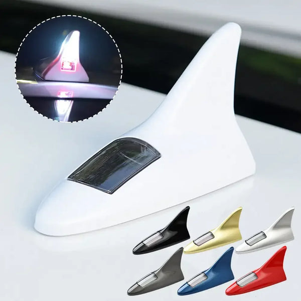 A white solar car antenna shark fin roof light with various colored fins displayed below.