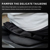 A black motorcycle seat pad is shown, designed to pamper the delicate tailbone.