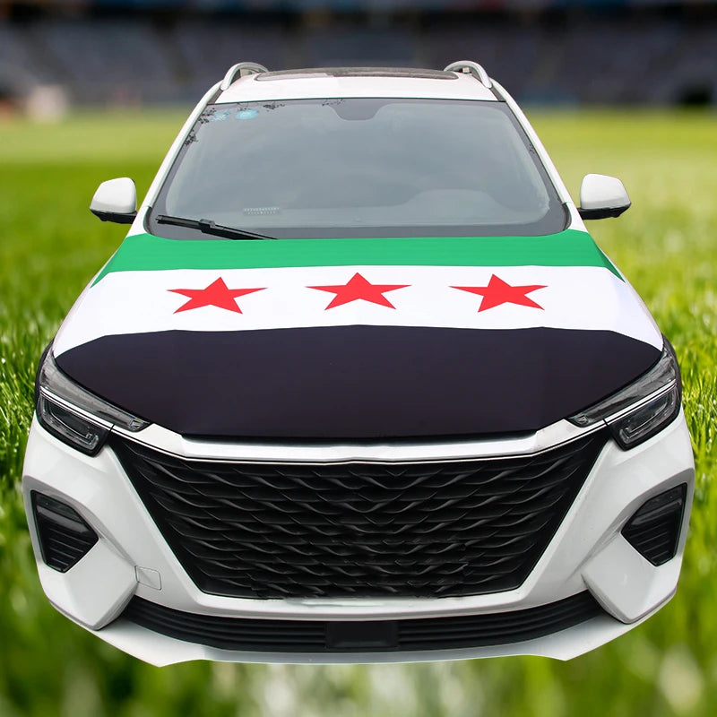 A white car hood decorated with a green, white, and red flag design featuring three stars.