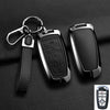 A black aluminum alloy key fob cover with a metal split ring attached to a leather strap.