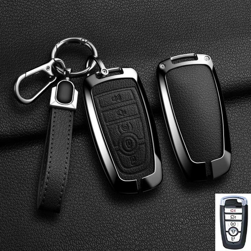 A black aluminum alloy key fob cover with a metal split ring attached to a leather strap.