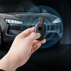 A hand holds a carbon fiber car key cover, demonstrating its fit for a Mercedes vehicle.