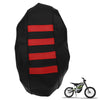Black seat covers with red stripes for an electric vehicle, shown next to a dirt bike.