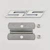 A silver metal emblem badge featuring the SS design and two threaded bolts.