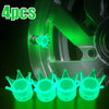 Quatre bouchons de valves lumineux et brillants pour roues, présentés sur fond sombre.
