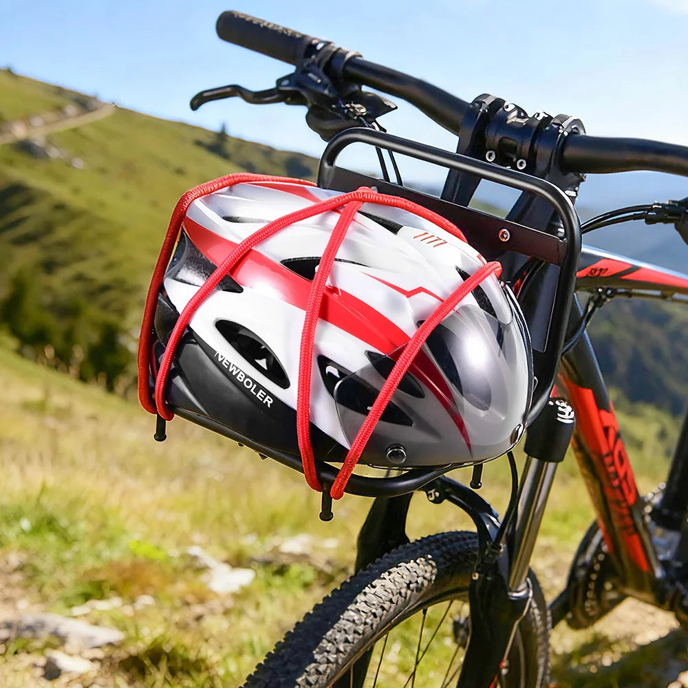 A black bicycle features a red and white helmet secured by a durable iron front rack in a sunny, grassy outdoor setting.