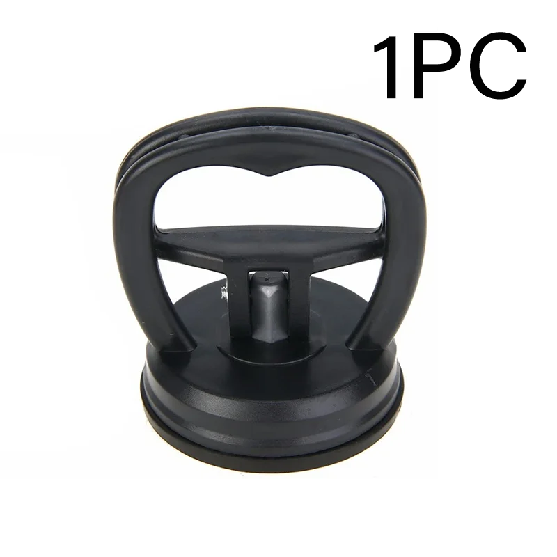 A black suction cup dent puller tool with a handle and base for bodywork repair.