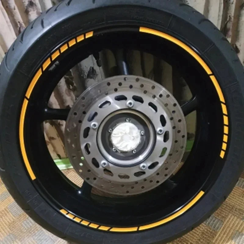 Close-up view of a black wheel rim with yellow reflective strips and a silver center hub.