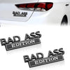 Black Bad Ass Edition logo decals applied to a white car's taillight area.