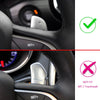 Gros plan du volant d'une voiture montrant un kit d'extension de leviers et une marque barrée indiquant qu'il n'est pas fait