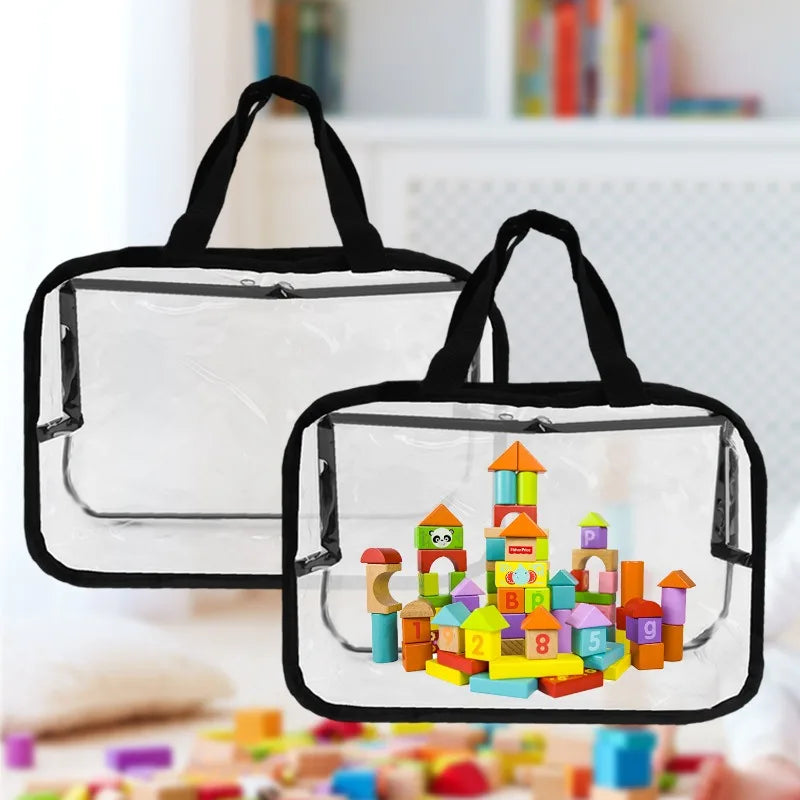 A clear PVC storage pouch with black handles holds colorful building toys and blocks.