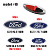A collection of Ford aluminum hood and trunk emblem badges in various sizes and blue colors.