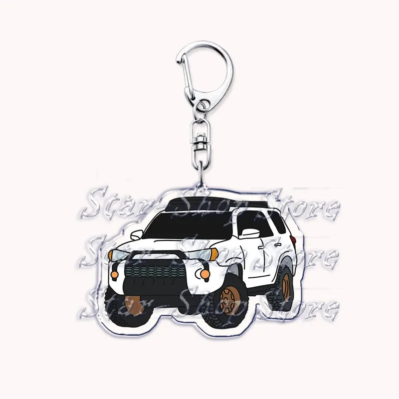 Silver acrylic keychain featuring a black off-road truck model.
