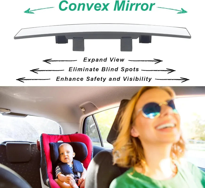 A woman smiling while driving, with a convex mirror mounted on the rearview mirror of her car.