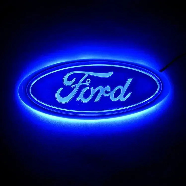 Blue neon glow of the Ford logo on a dark background.